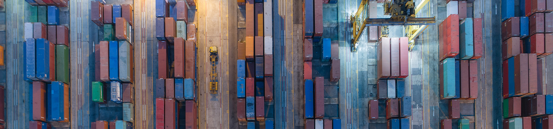 Logistics And Transportation Of Container Cargo Ship And Cargo With Working Crane Bridge In Shipyard At Sunrise