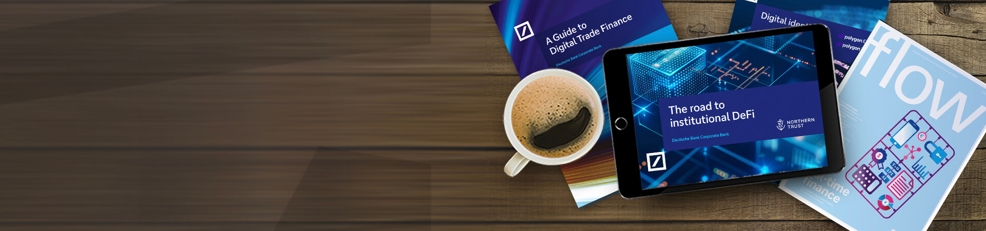 Image of a tablet, coffee, flow magazine and a paperpack version of A guide to trade finance